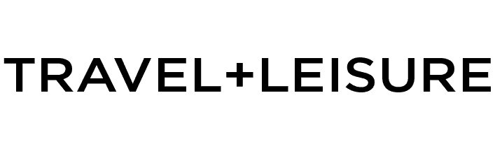 The words "TRAVEL + LEISURE," known for featuring the best tour operators of 2022, are displayed in bold, black capital letters on a light gray background.