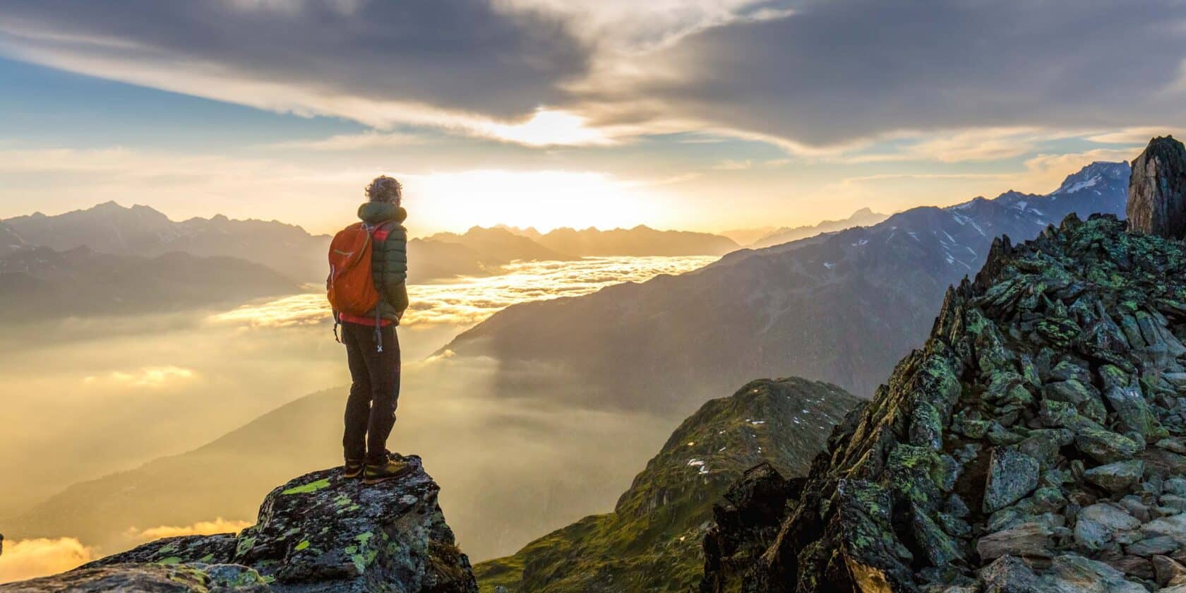 A hiker observing mountains.