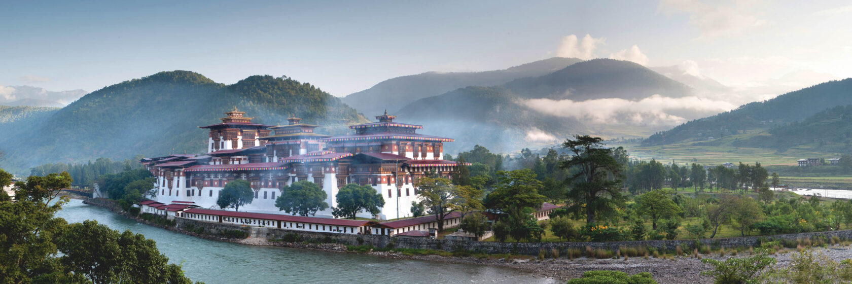 Misty dawn view of the Punakha Dzong located at the junction of the Mo Chhu Mother River and Pho Chhu Father River in the Punakha Valley, Bhutan.