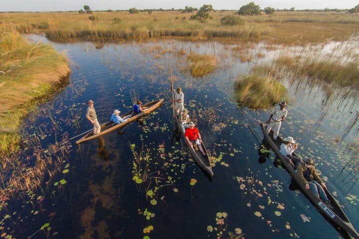 Travelers riding canoes in Botswana.