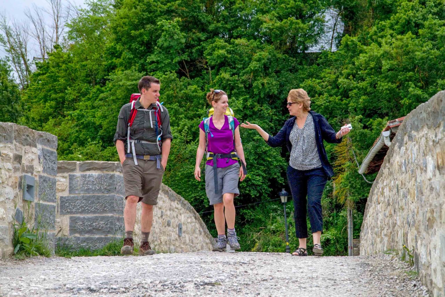 Two hikers and a guide on the St. James route on the Camino de Santiago.