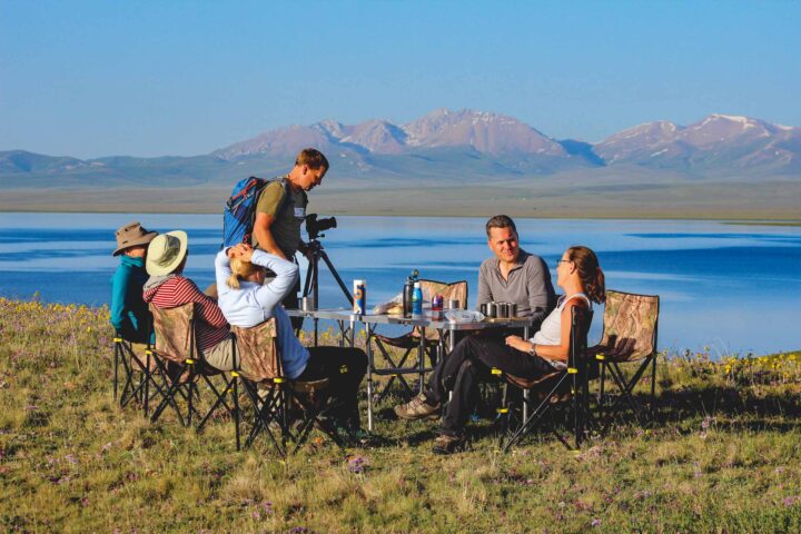 A group of tourists relaxing outside in Central Asia.