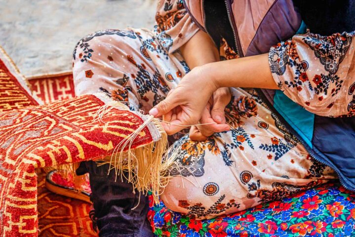 An Uzbek carpet weaver.