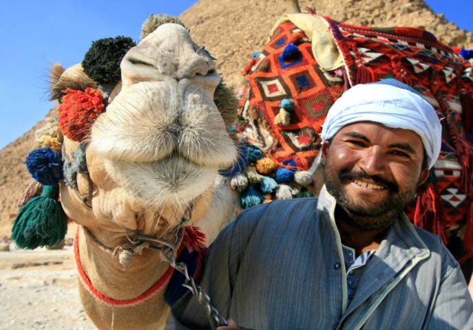 A camel and an Egyptian man.