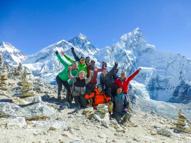 A group of happy travelers at Mt. Everest.
