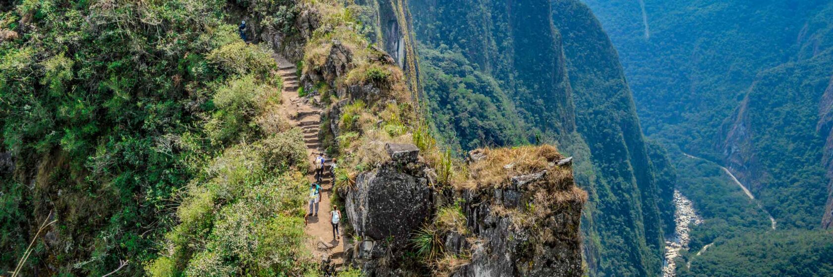 A group of hikers on a set of stairs on the Inca Trail in Machu Picchu.