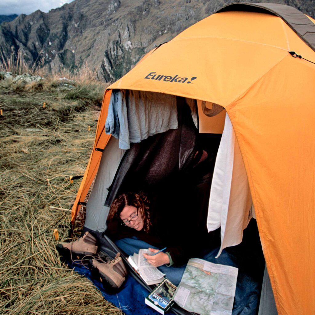 A traveler resting in a tent.