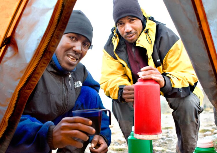 Two porters in Kilimanjaro.