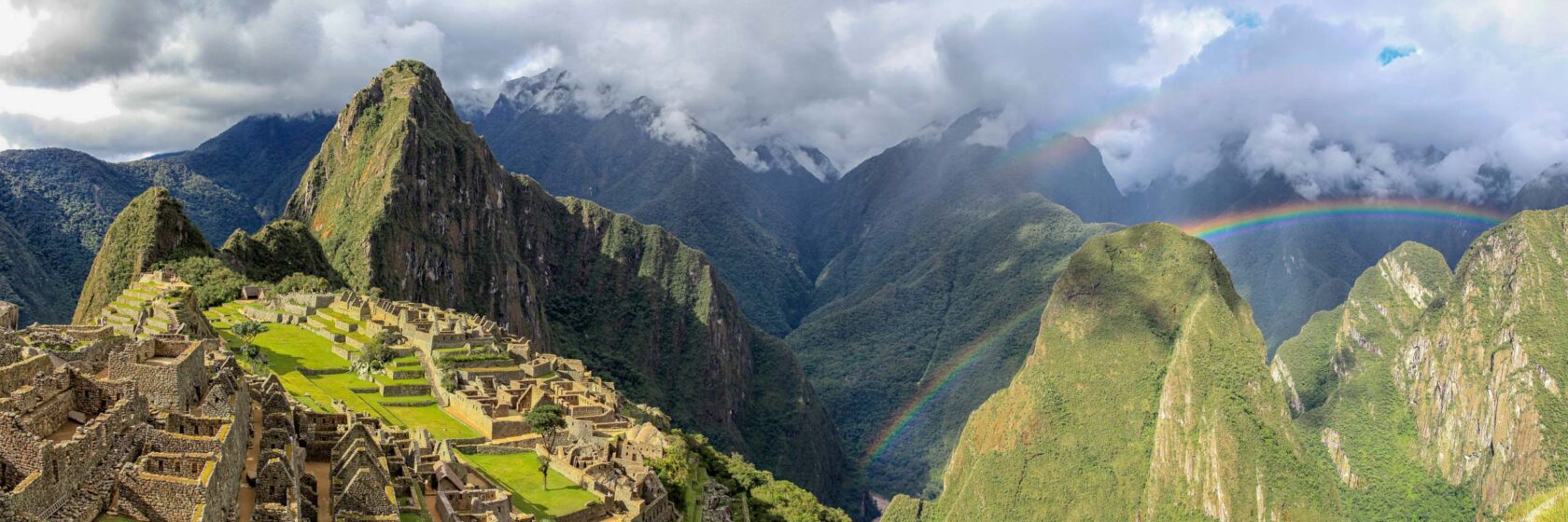 Macchu Picchu in late afternoon with rainbow in the background.