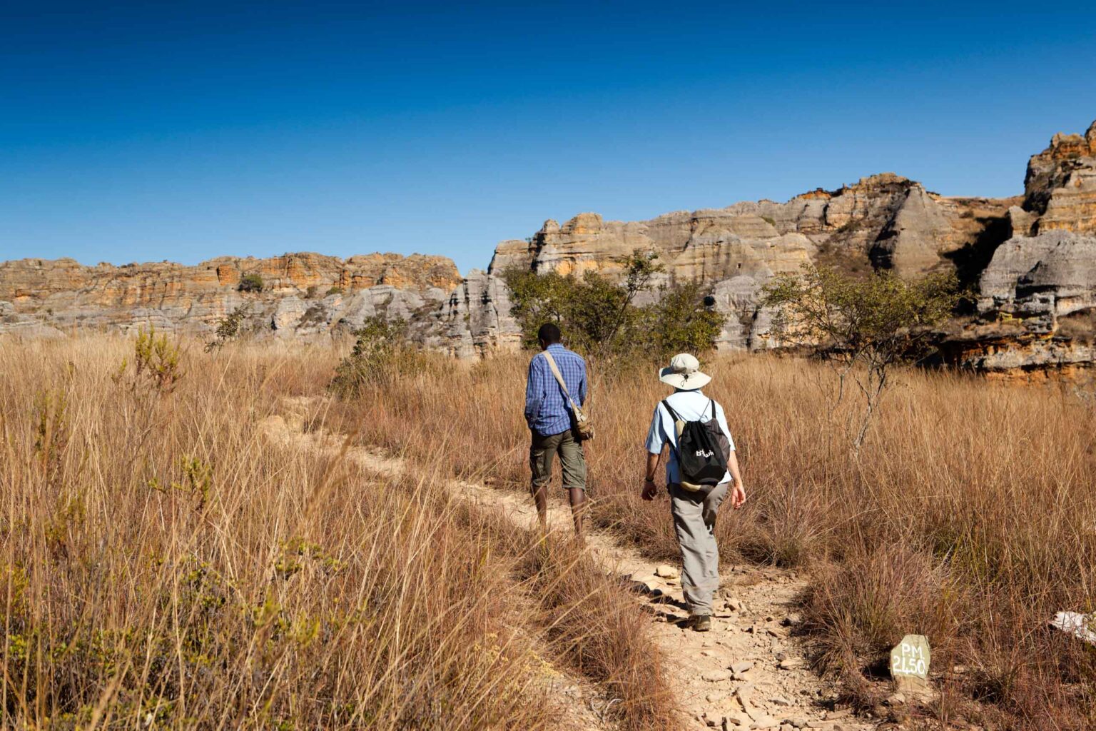 Two hikers amongst the tsingy limestone formations in Isalo National Park.