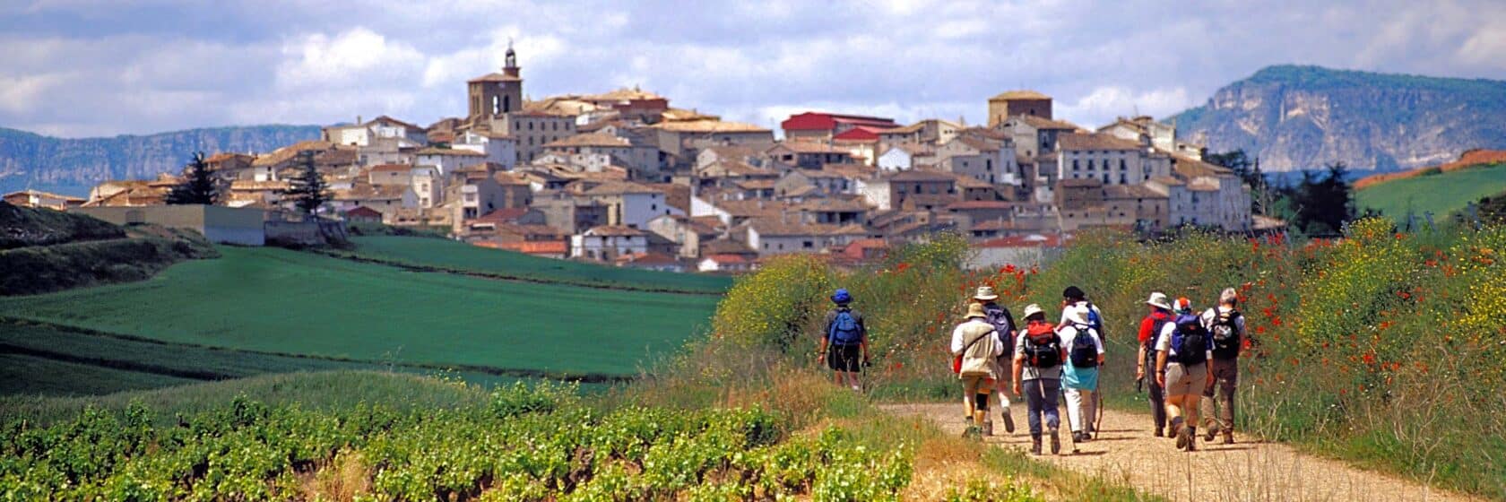 Spanish town along camino de santiago group of walkers.