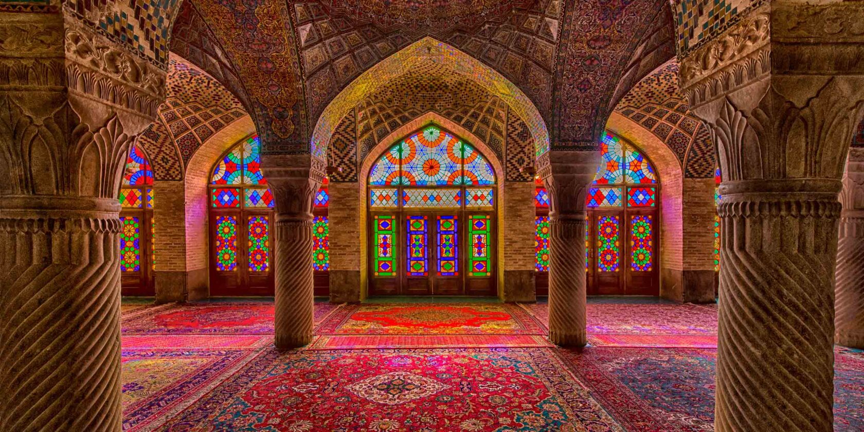 Interior with beautiful and artistic windows with stained glass inside the Nasir ol Molk Mosque (also "Pink Mosque) in Shiraz, Iran.
