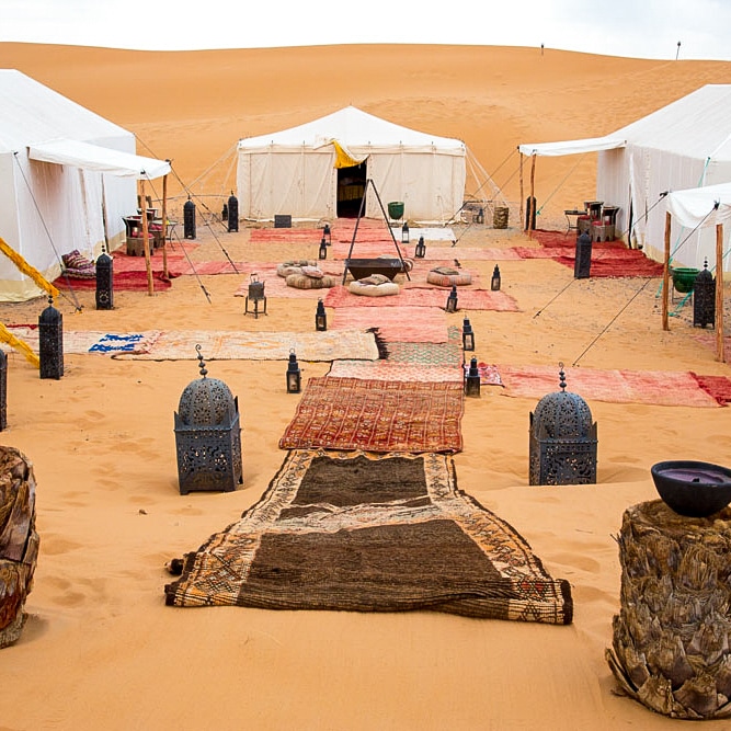 Large, walk-in tents and Moroccan carpets in a luxury Sahara Desert camp.