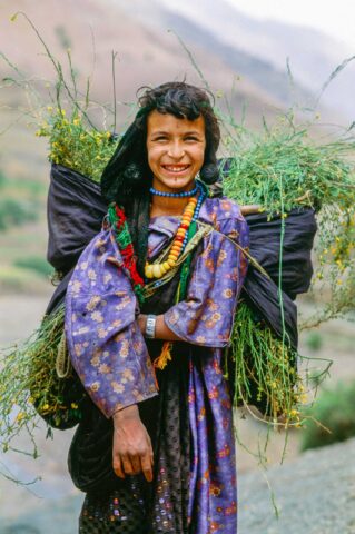 A girl carrying plants in Morocco.