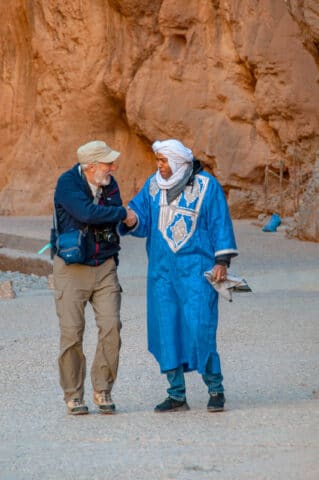 A photographer alongside a Moroccan man.