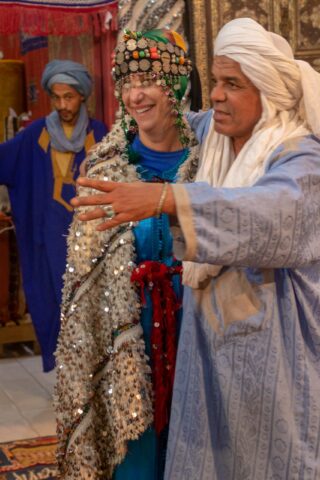 A tourist trying on traditional clothing in Morocco.