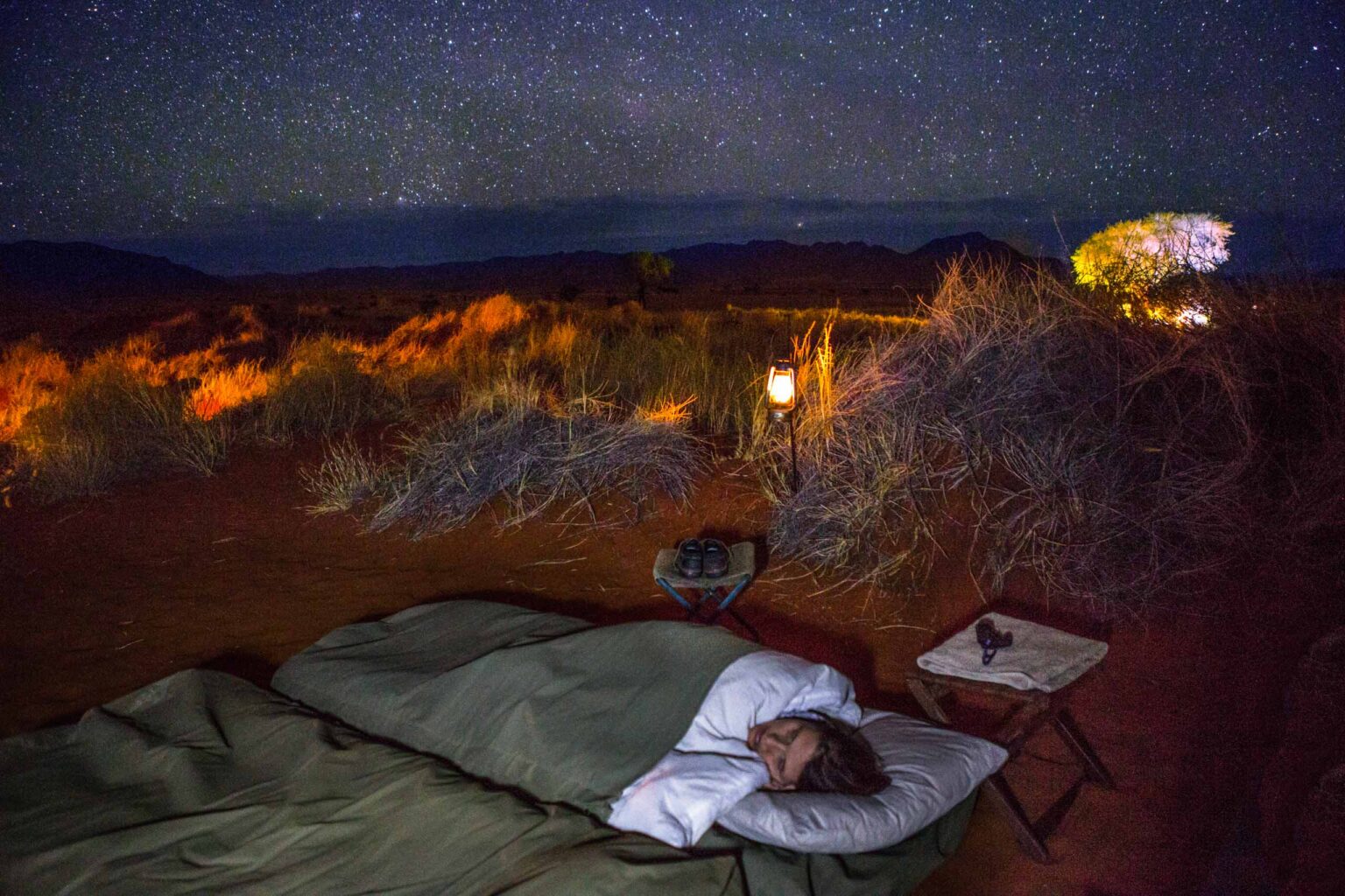 A traveler sleeping at a campsite on Tok Tokkie trail in Namibia.