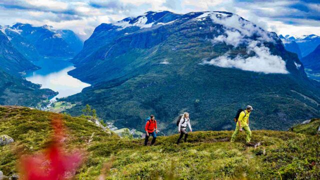 A group of travelers hiking mountains in Norway.