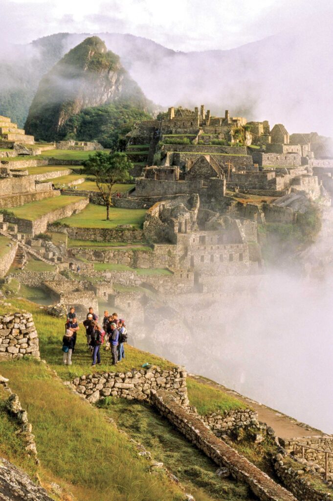 A group of tourists admiring Incan Ruins.