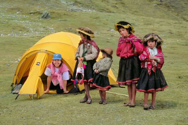 Local Quechua girls visit a trekker in her tent.