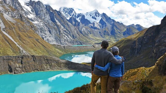 A couple enjoying a view of mountains in Peru.
