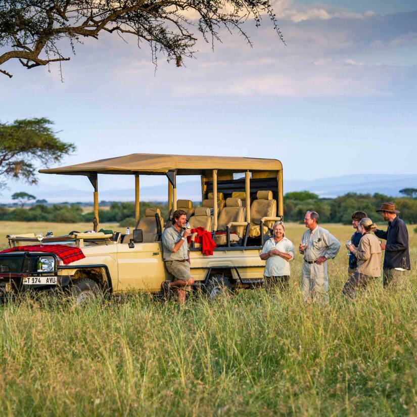 A group of people enjoying wine during a safari in Tanzania.