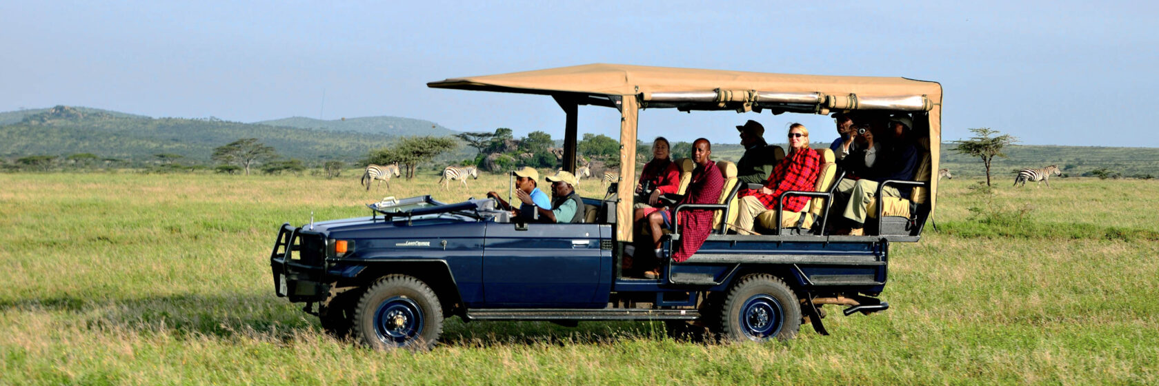 Safari vehicle with travelers.