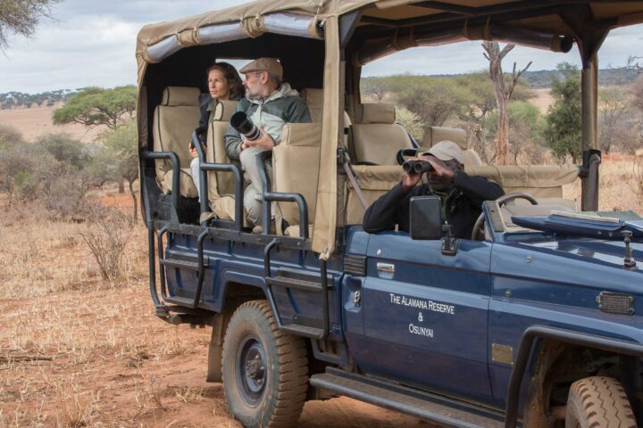 Photographers on a safari vehicle in Tanzania.