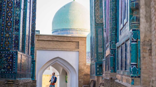 A woman admiring memorial buildings in Uzbekistan.