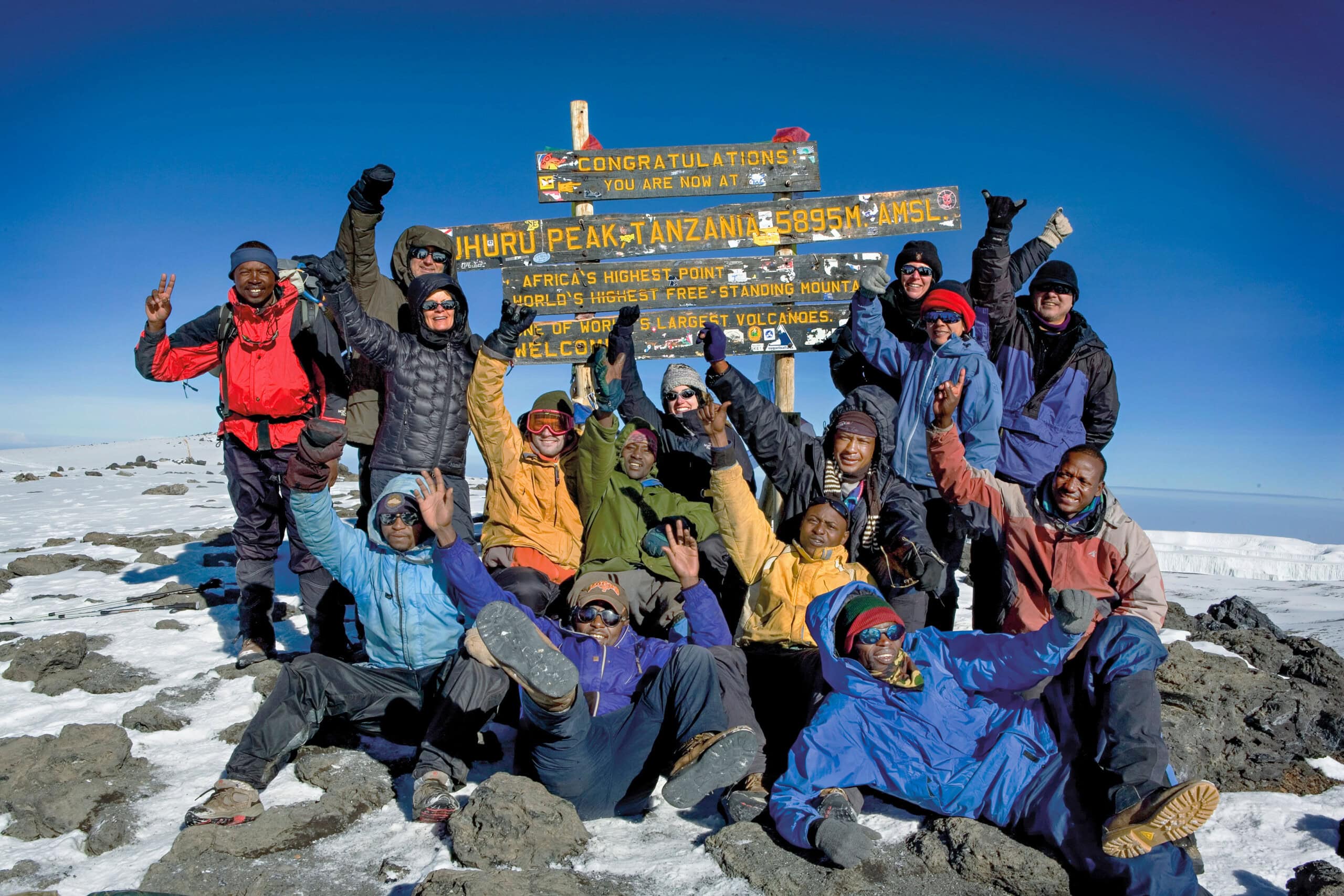 https://www.wildernesstravel.com/wp-content/uploads/2023/06/11-KILSHIRA-group-of-climbers-kilimanjaro-summit-uhuru-peak-tanzania-scaled.jpg
