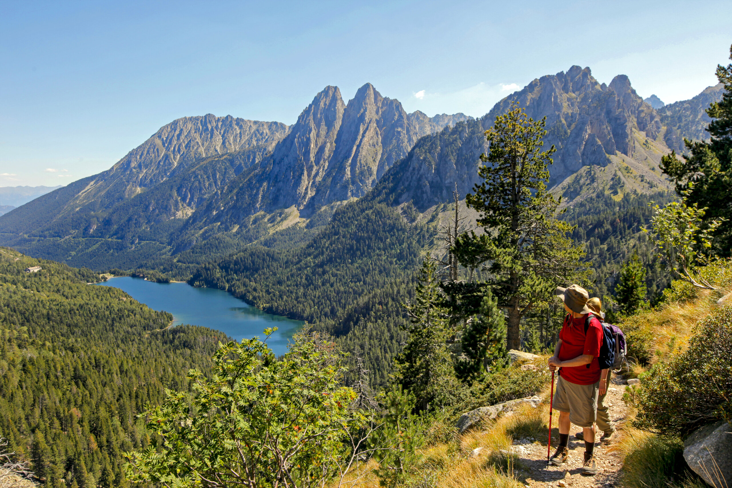 https://www.wildernesstravel.com/wp-content/uploads/2023/06/11-PYRENEES-hikers-black-lake-aiguestortes-national-park-catalonia-spain-scaled.jpg