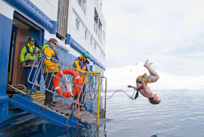 A tourist diving in Antartica.