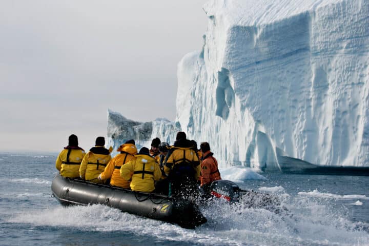 A group of tourists on a boat on an expedition in the Arctic.