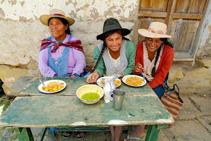 Three indigenous women enjoying lunch together.