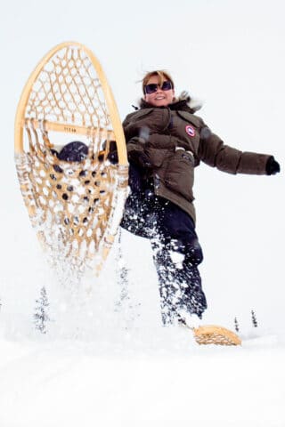 A tourist snow shoeing in Canada.