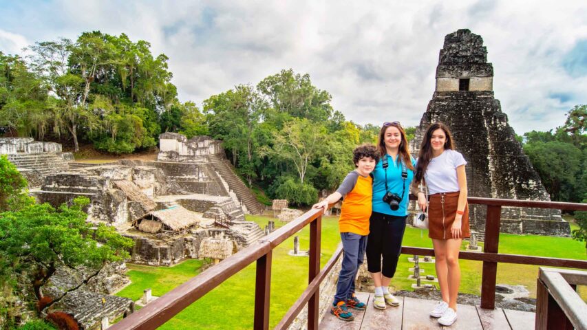 A family posing in front of the Temple of the Great Jaguar.