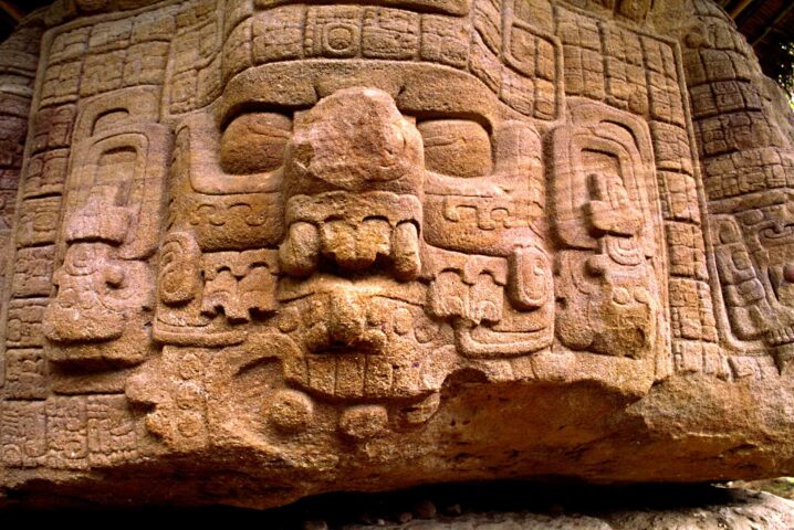 A Mayan zoomorph with beautifully carved glyphs and face of god or a ruler.