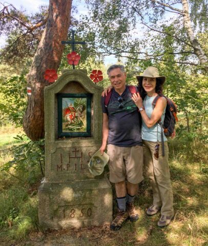 A couple posing by a gravestone in Czech Republic.