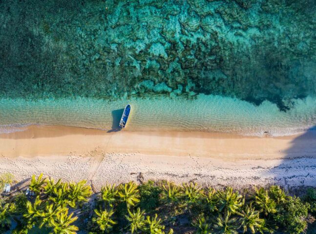 An aerial view of a boat by the beach.