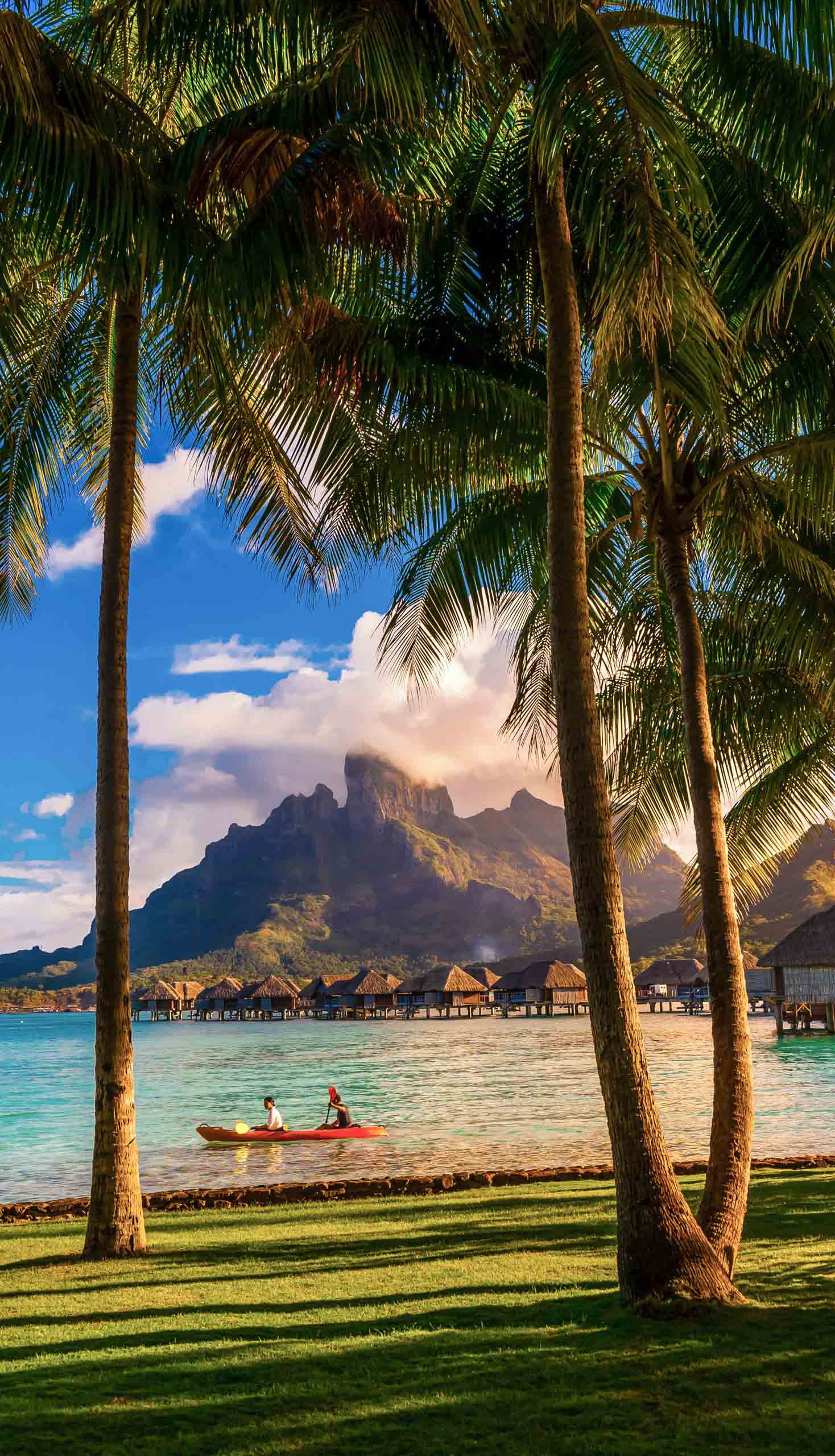 People kayaking in a resort in the French Polynesia.