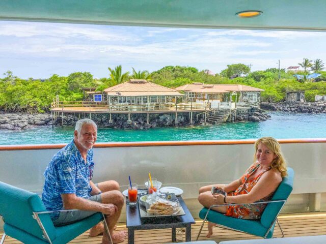 A couple enjoying a meal together on a boat in the Galápagos Islands.