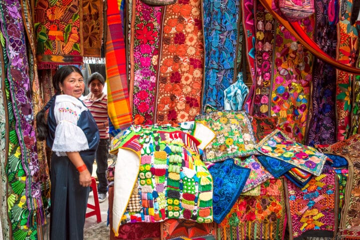 Ecuador, Otavalo Indian woman sells products of weaving