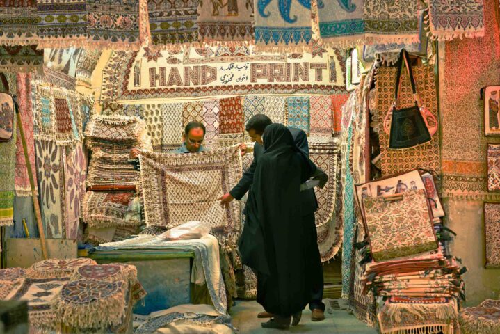 A shop in a market that sells rugs.