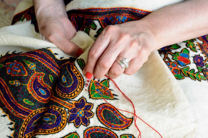Close-up of woman's hand while embroidering.
