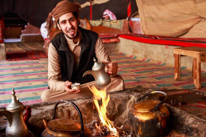 A Bedouin man serving Arabic coffee.