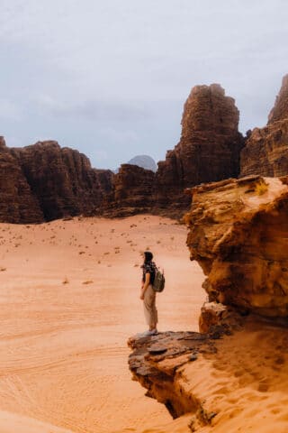 A tourist on a cliff in Jordan.