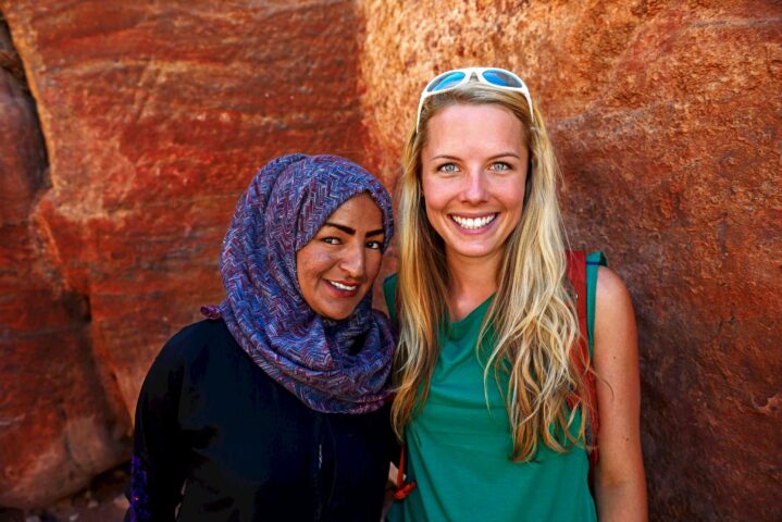 A tourist and a local Bedouin woman.