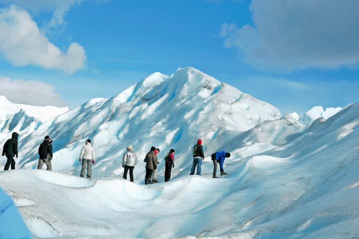 A group of tourists on snow peaks in Patagonia.