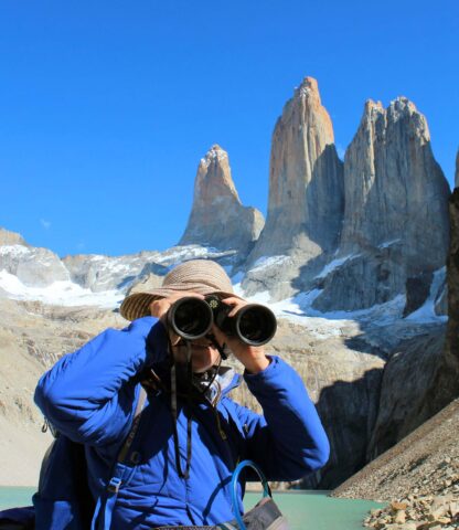 A tourist using binoculars in Patagonia.