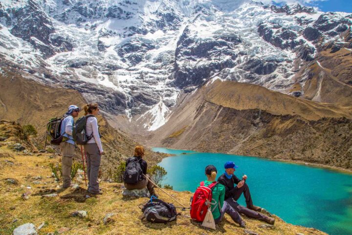 A group of hikers enjoying a view of mountains in Peru.